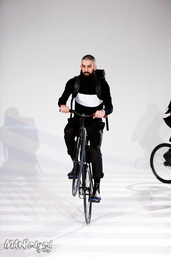 A model popping a wheelie at Uri Minkoff's men's fashion presentation.