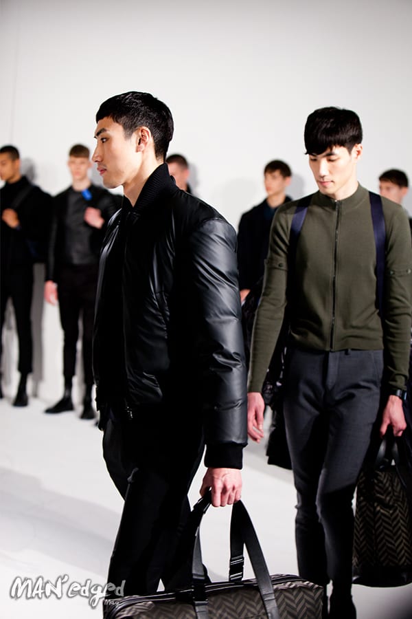 Model wearing a men's black puff coat.